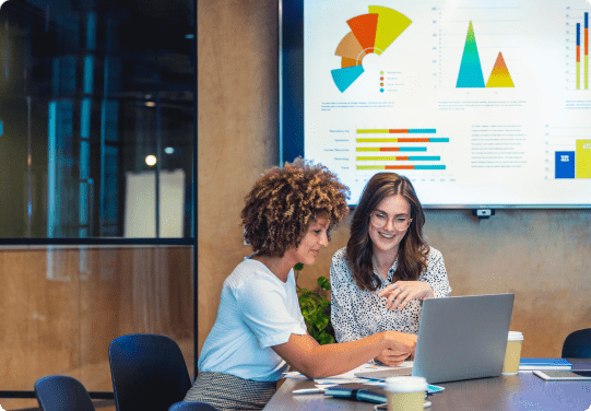 Two women collaborating in a modern office.